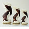 Pelicans Sitting On Posts